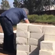 Image for article titled Artist building wall of cheese at Mexico border to “Make America Grate Again”